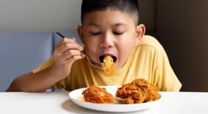 boy eating fried chicken